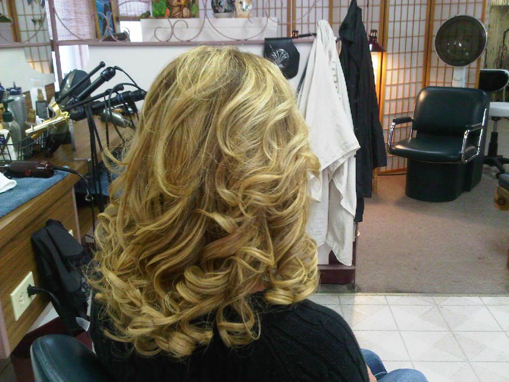 Big blonde highlighted curls styled at McDonald's Hair Unlimited
