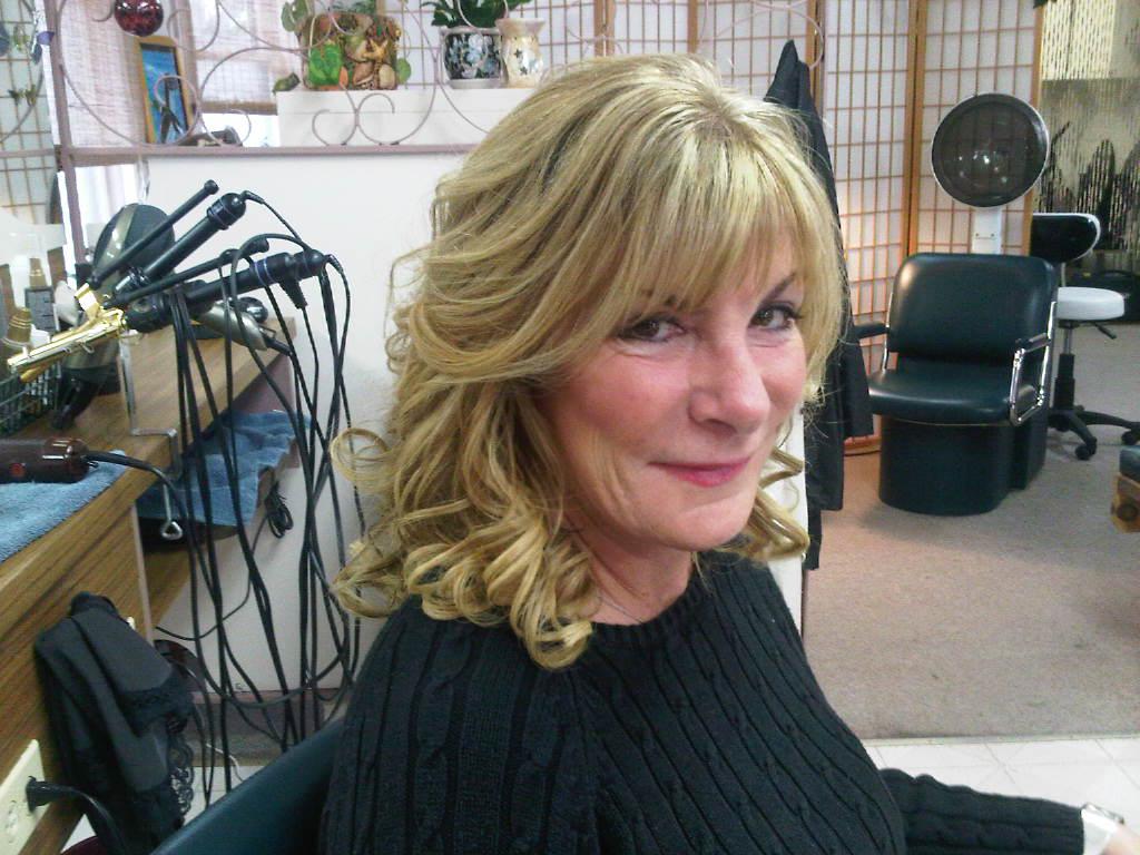 A client with a soft blonde blowout at McDonald's Hair Unlimited