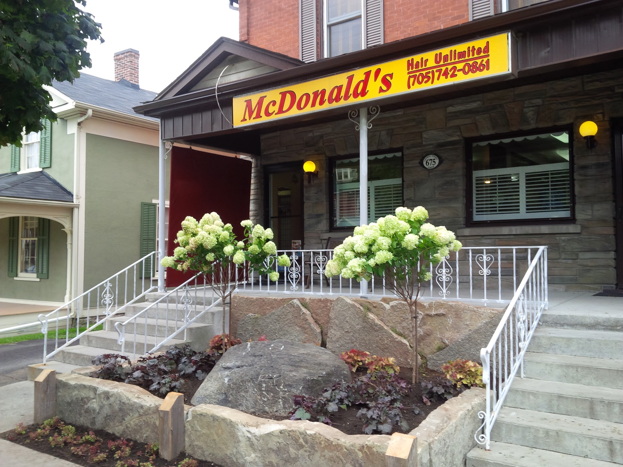 McDonald's Hair Unlimited storefront with hydrangeas in full bloom